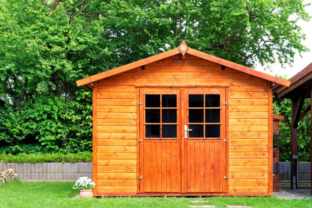 Frontal view of wooden garden shed glased in teak color